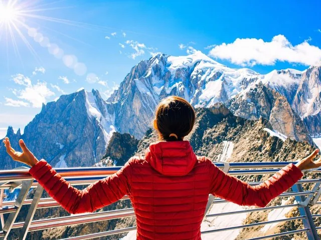 Woman in red jacket looking at Monte Bianco peaks