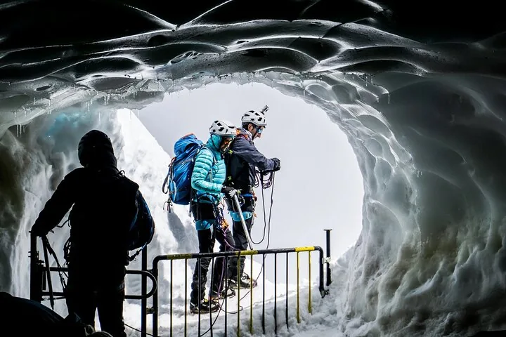 People standing at the entrance of an ice cave on Monte Bianco