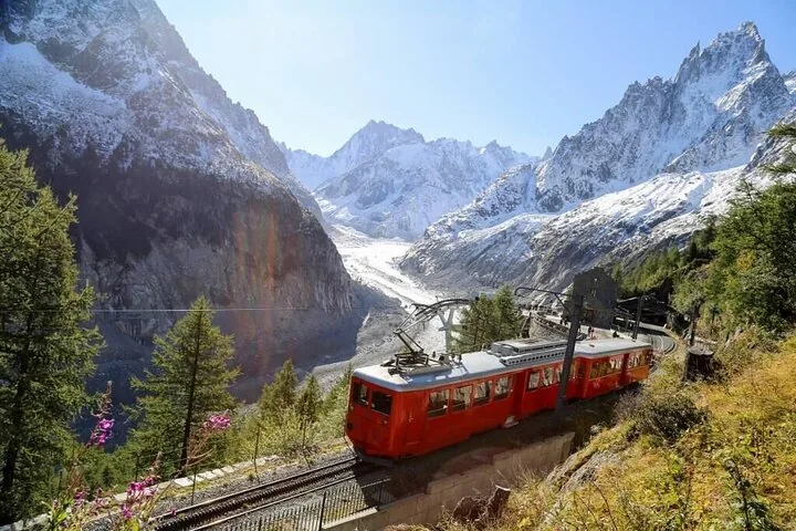 Red mountain train descending from Monte Bianco with glacier view