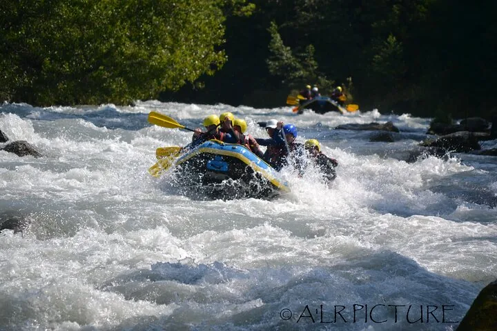 Two rafts navigating rapids on a sunny day near Monte Bianco
